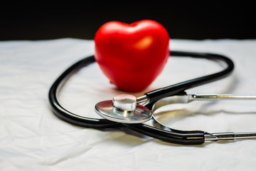 Medical stethoscope and red heart.