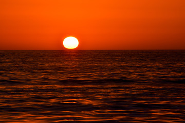 Red sunset sunrise over ocean sea. Beautiful Sunrise. Glowing sea sunrise. Atlantic Sunset in  Florida, USA.