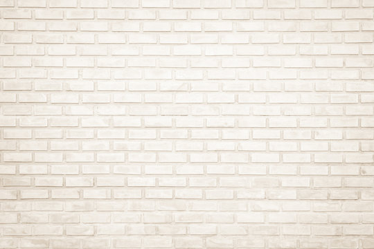Background of wide cream brick wall texture. Old brown brick wall concrete or stone wall textured, wallpaper limestone abstract flooring/Grid uneven interior rock. Home or office design backdrop.