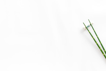 Chopsticks - green wooden utensil for sushi and rolls - on white background top-down copy space