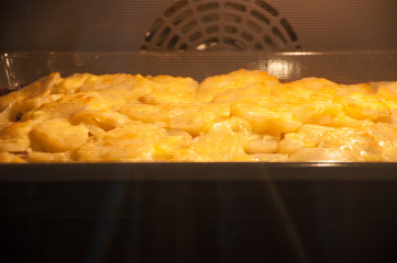 home cooking potatos with chicken in oven.