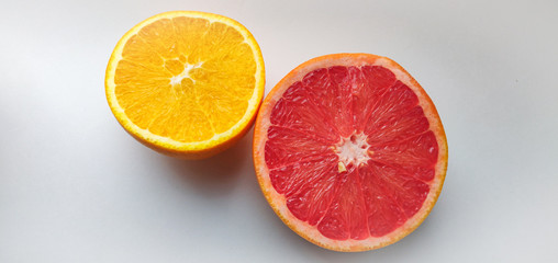 cutaway orange and grapefruit on a white background