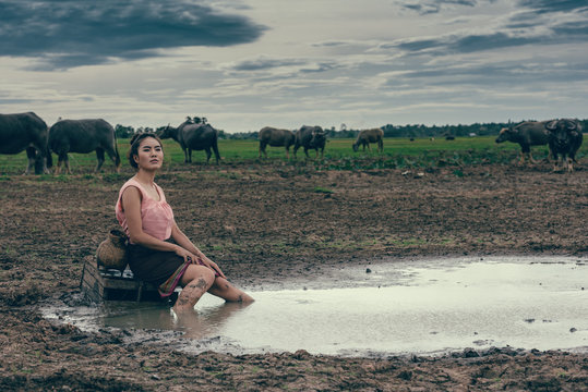 Portrait of rural women wear Thai dress with buffalo.