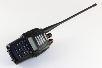 Black modern portable radio LPD PMR transmitter with antenna on white background, walkie-talkie outdoor communications