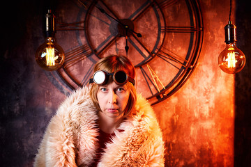 Ugly strange girl in unusual glasses in a strange dark room with a clock on the wall and the light...
