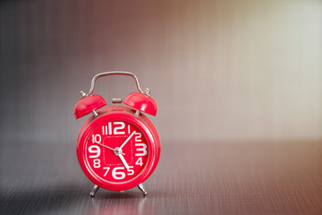red alarm clock  in dark background