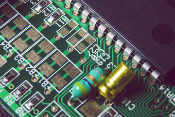 Green electronic board with chips and components.