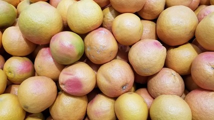 pile of red grapefruit in the market
