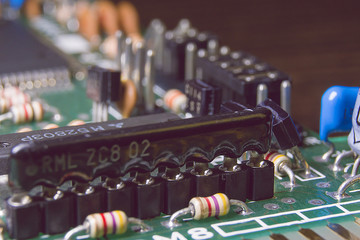 Green electronic board with chips and components.