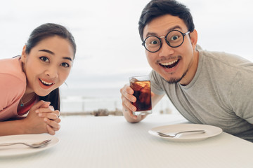 Lover couple having a date at the restaurant on the beach.