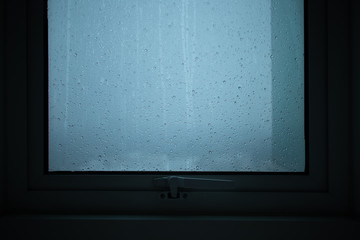 Rains run through the windows of the condominium room.