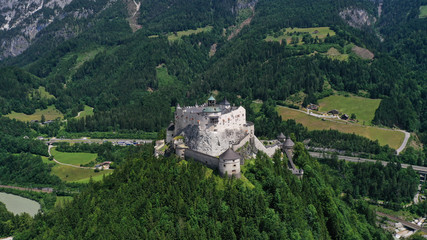 Fototapeta na wymiar Aerial panoramic view of Hohenwerfen Castle, Austria. Medieval rock fortress in Alpine mountains with spruces. Overlooking the Werfen town in Salzach valley. Summer.