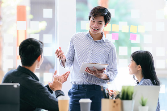 Business People Discussing, Talking And Smiling During Conference In Modern Office.