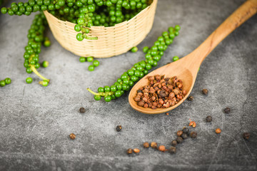 peppercorns on basket and dark background - fresh green peppercorn and black pepper seed for ingredients cuisine thai food herbs and spices