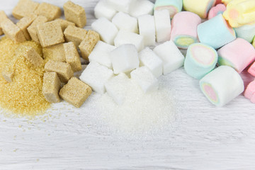 Brown sugar , White sugar , sugar cubes and colorful candy sweet on the table background / No sugar in diet causes obesity diabetes and other health problems