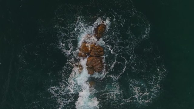 Aerial Drone Shot of Ocean Rocks in Calella de Palafrugell Coastline and City During Sunrise