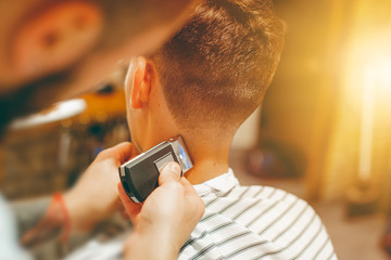 Barber shears the hair on her head with scissors. Haircut close-up. Barber shop