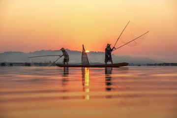 Fisherman on sunrise background at Thailand Countryside