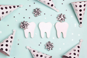 Happy Dentist's Day concept with teeth and holiday caps.