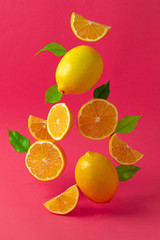 Lemons hovering in the air against bright pink background