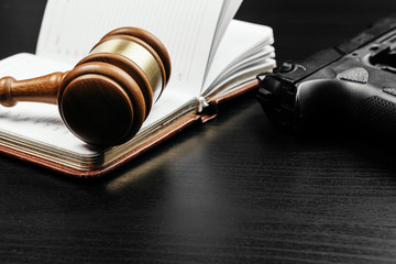 Brown wooden judge mallet on the background of open book
