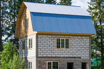 Construction of a small two-storey private residential building, cottages near the forest