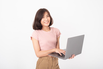 Cute Asian teen woman is working with computer on white background