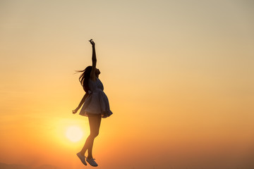 Young asia woman jumping in the sky and feeling free,happy