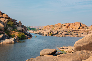 Ancient temple ruins near river in Hampi