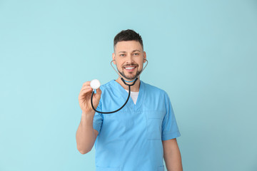 Male cardiologist on color background