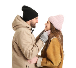 Portrait of happy couple in winter clothes on white background