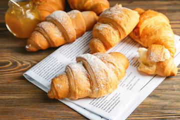 Tasty fresh croissants on table