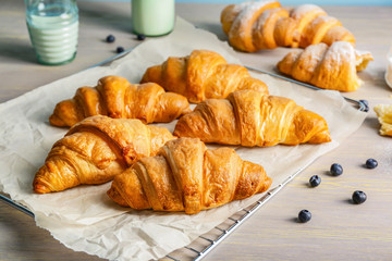 Tasty fresh croissants on table