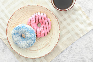 Plate with sweet tasty donuts on table