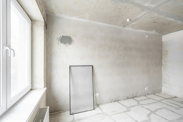 Empty interior for design, gray concrete wall. Empty room. Space for text and picture. Concrete walls, slabs, interior of a new residential building. Partitions in a new apartment.