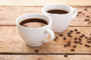 Cups of hot coffee on table