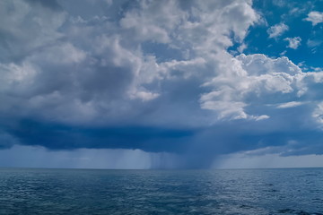 Naklejka na ściany i meble view of heavy raining in the sea with cloudy sky background, Ra Wi island, Tarutao National Marine Park, Stun, south of Thailand.
