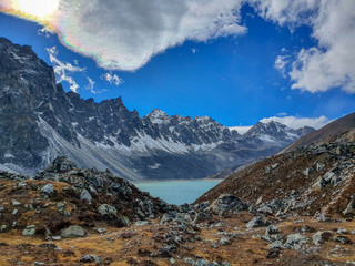 Donag Tsho, the fourth Gokyo lake., hills and snow-capped mountains. Sunny day and marvellous blue sky. Gokyo lakes and Cho Oyu base camp trek, Solokhumbu, Nepal.