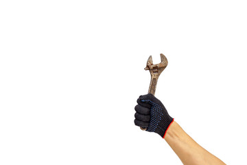 Rusty wrench, man's hand holding spanner, isolated. Rusty adjustable wrench in gloved hand