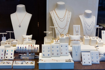 Gold jewelry at showcase of jewelry shop