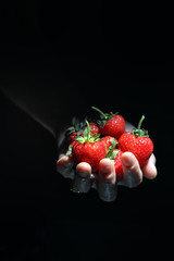 Woman Hand Holding Palm Full Of Strawberries