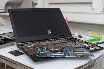 disassembled laptop is on the table. computer repair