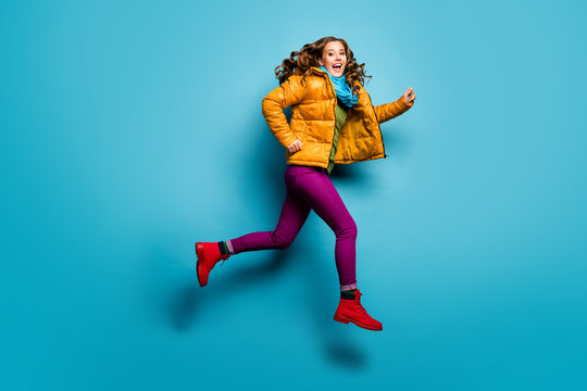 Full Body Profile Photo Of Pretty Lady Jumping High Rushing Low Prices Shopping Wear Casual Yellow Overcoat Scarf Magenta Pants Red Shoes Isolated Blue Color Background