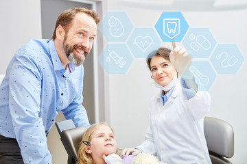 Dentist shows kid choosing touchscreen