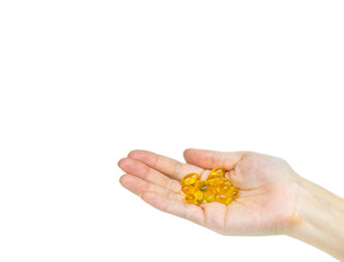 Fototapeta premium Hand holding Fish oil capsules on isolated white.