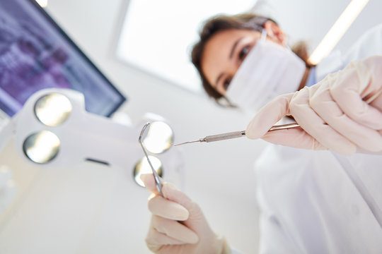 Dentist holds hand instruments for examination