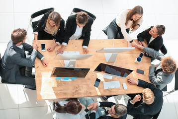 top view. happy employees shaking hands during a meeting