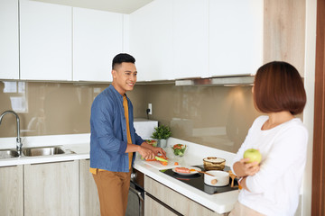 Photo of happy young couple preparing eat in the kitchen together. Family concept.