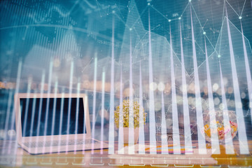 Forex graph hologram on table with computer background. Double exposure. Concept of financial markets.