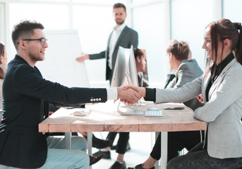 business partners shaking hands during a business presentation.